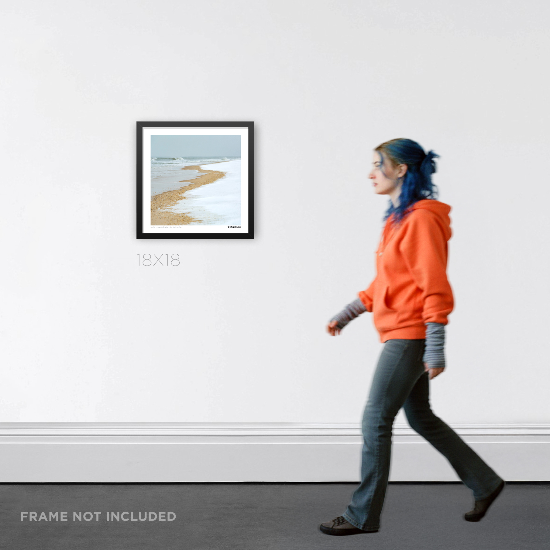 18X18 square framed winter beach Graphic Design print by RobxWallace, displayed on a white gallery wall with a person walking past for scale.