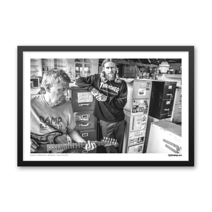 Close up view of a 20x30 wide framed music poster print showcasing a collaborative session between Greg Ginn and Mike Vallely inside the SST warehouse.