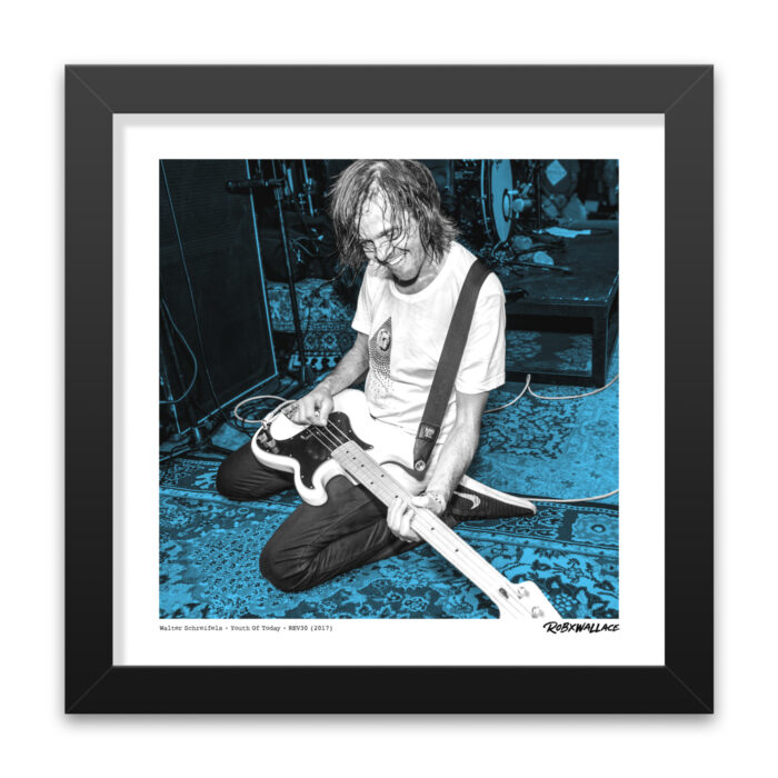 Detailed close up look at a 12x12 square framed underground hardcore fine art print the energy and blue-accented stage presence of punk legacy pioneer Walter Schreifels.