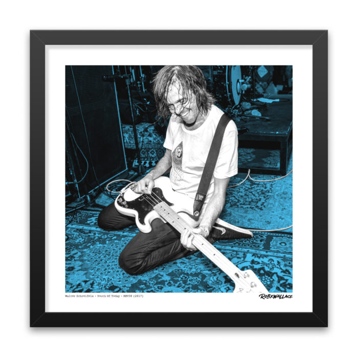 Close up view of an 18x18 square framed NYHC poster print featuring a high-intensity black and white live capture of Walter Schreifels tinted with striking blue accents.