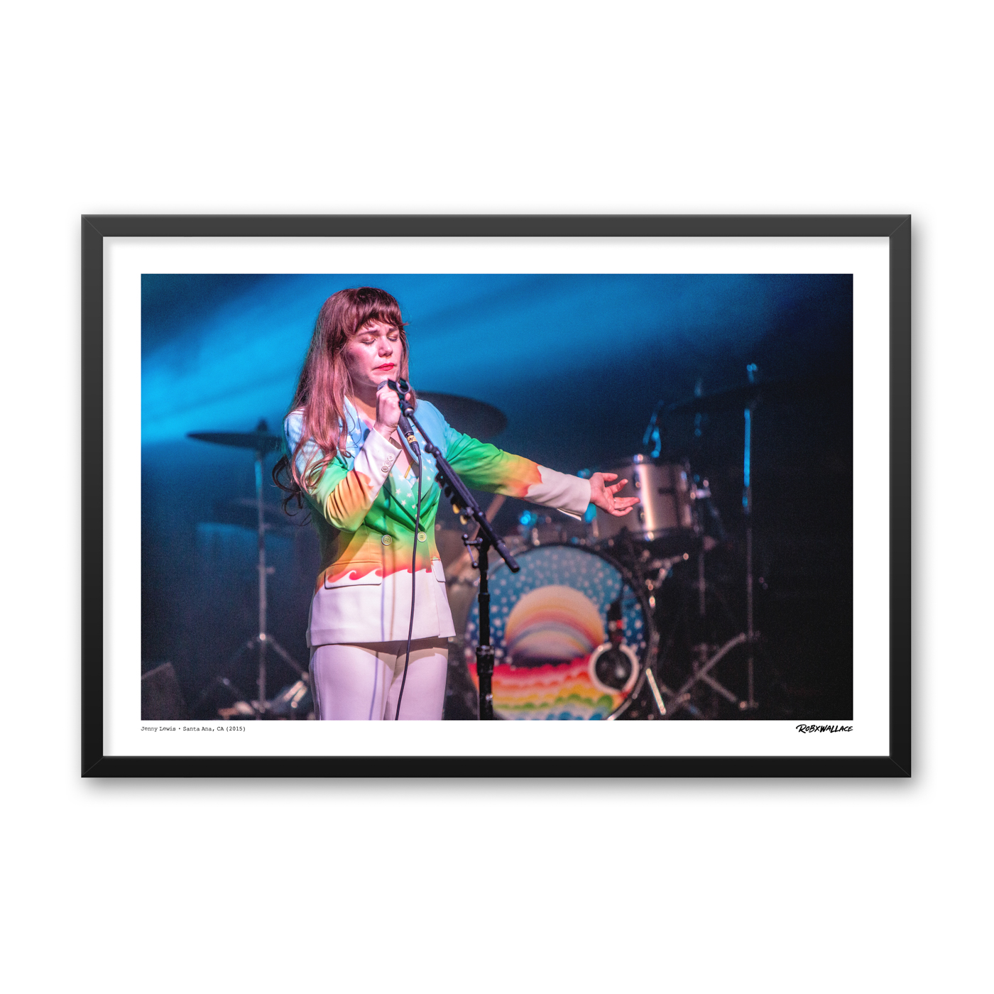 Close up view of a 24x36 wide framed music poster print showcasing singer songwriter Jenny Lewis performing classics like Portions for Foxes live on stage under atmospheric venue lighting.