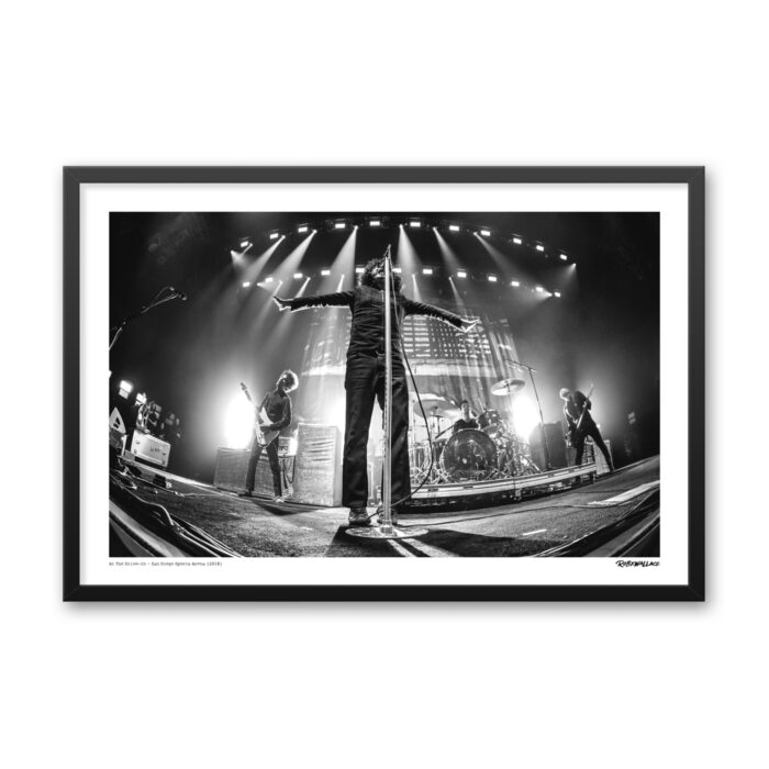 Close up view of a 24x36 wide framed alternative rock poster print showcasing the live performance of At The Drive-In at San Diego Sports Arena.