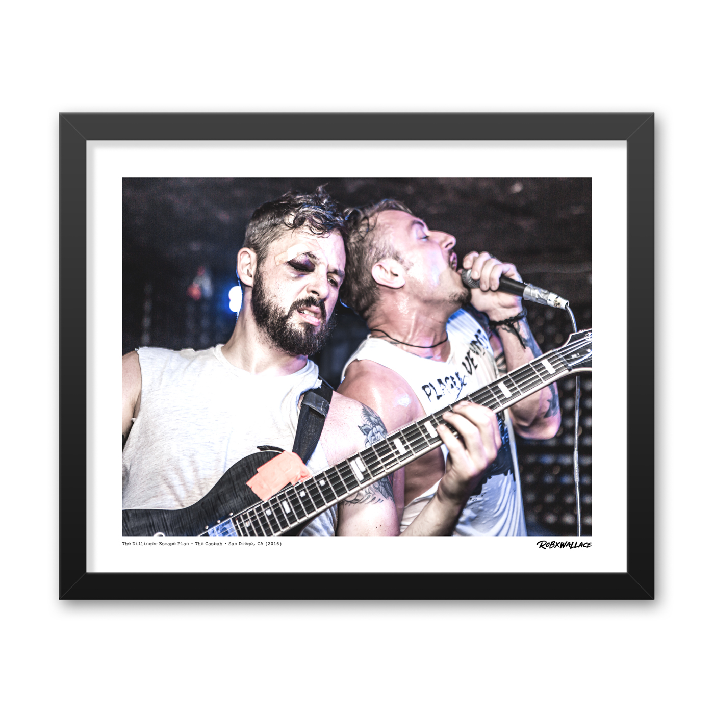 Detailed close up of a 16x20 framed avant-garde metal poster print the live chaos and technical precision of Ben Weinman and Greg Puciato at a packed San Diego venue.