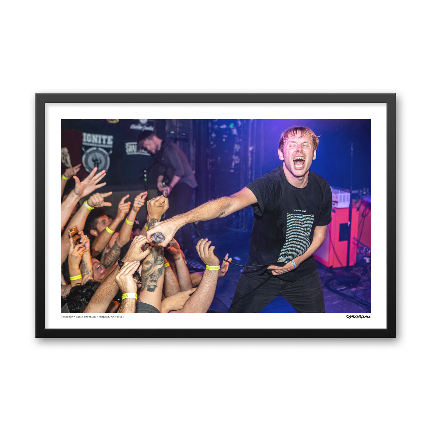 Close up view of a 24x36 wide framed emo music poster print showcasing vocalist Geoff Rickly and the crowd interaction inside a tight venue layout.