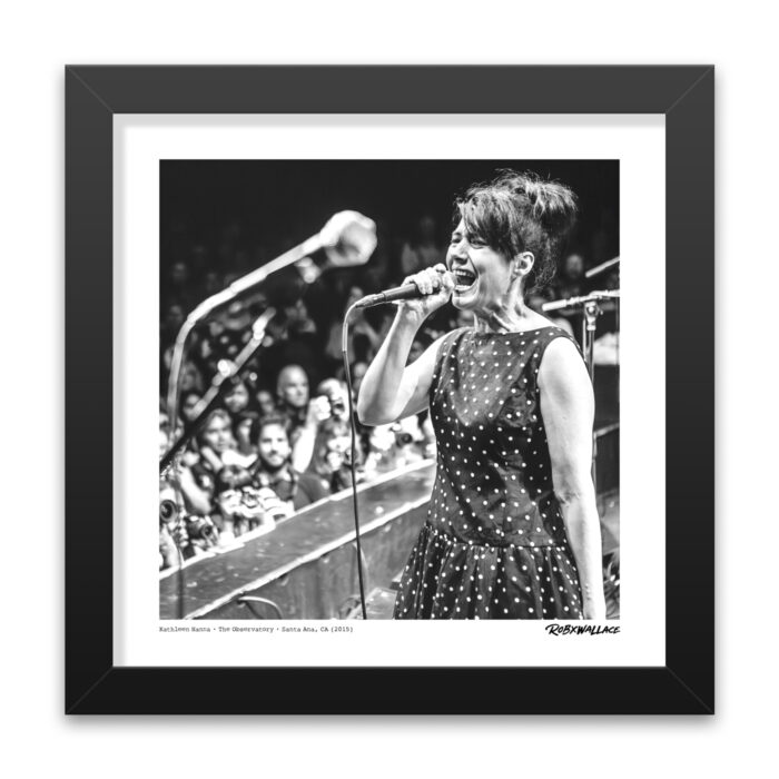 Detailed close up of a 12x12 square framed fine art music print of Kathleen Hanna performing with The Julie Ruin, as featured at the Punk Rock Museum.