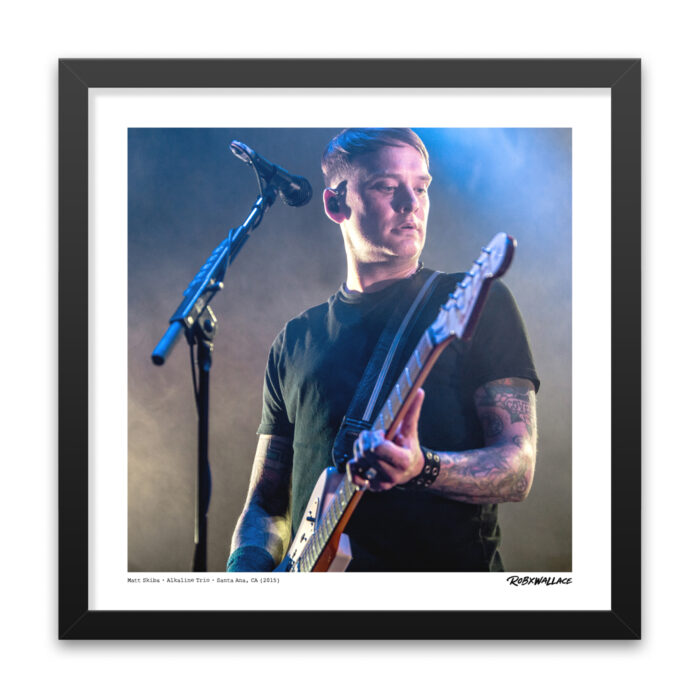 Close up view of an 18x18 square framed alternative rock poster print Matt Skiba leaning into his guitar under moody, atmospheric stage lighting reflecting the Crimson and Good Mourning era.