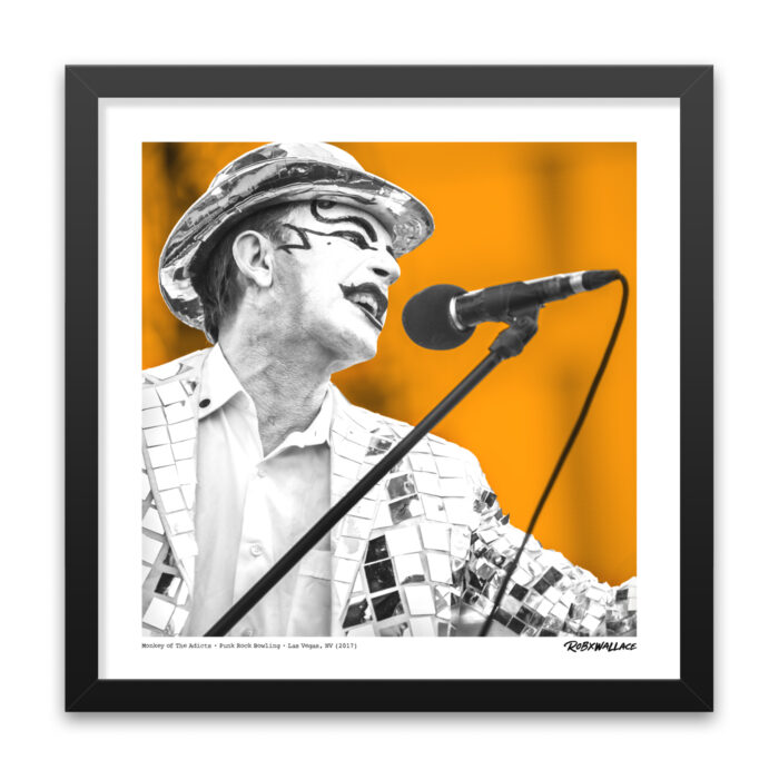 Close up look at an 18x18 square framed fine art poster print frontman Monkey Warren in his signature bowler hat, joker makeup, and mirrored suit.