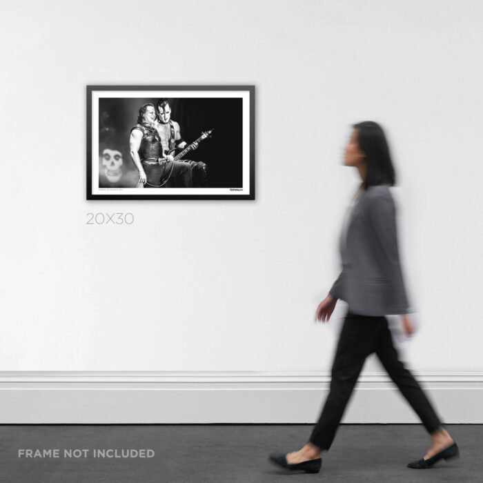 20x30 framed alternative music history photo print documenting a rare onstage smile between Danzig and Doyle in Colorado, styled on a clean interior wall for product scale.