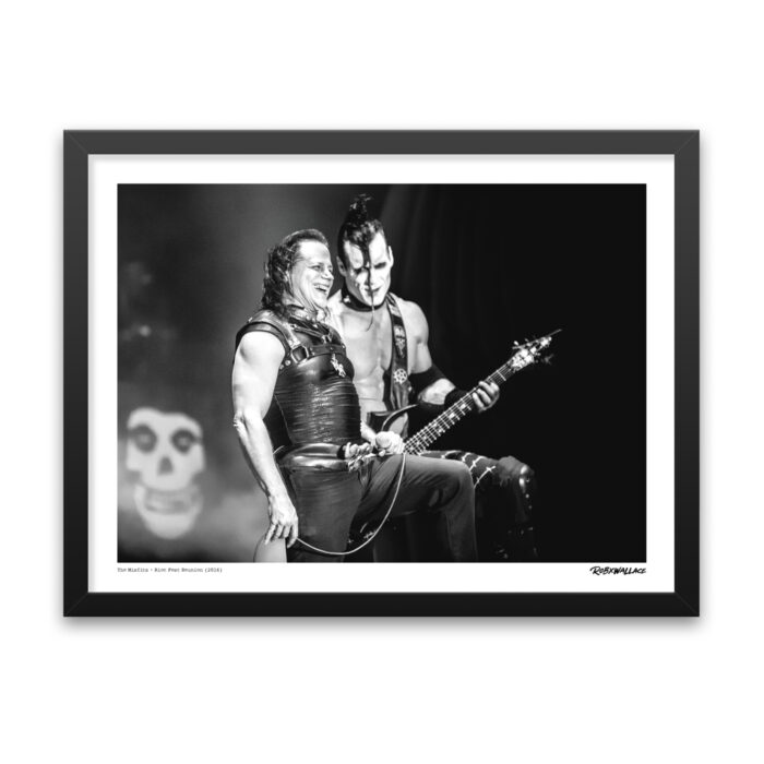 Detailed view of an 18x24 framed punk rock wall art print showcasing a rare candid interaction between Glenn Danzig and Doyle mid-performance in Denver, Colorado.