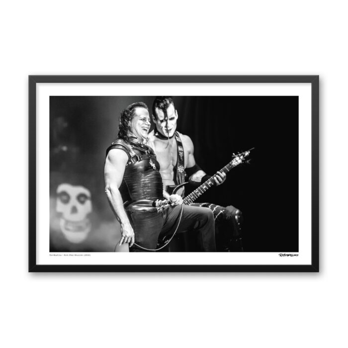 Close up view of a 24x36 wide framed horror punk poster print showcasing an unscripted, lighter interaction between Glenn Danzig and Doyle on stage during their 2016 reunion.