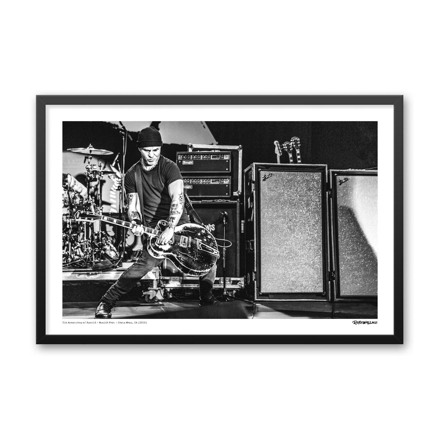 Close up view of a 24x36 framed punk poster print featuring Tim Armstrong leaning into his custom scrawled DIRTY guitar silhouette under dramatic festival stage lights.