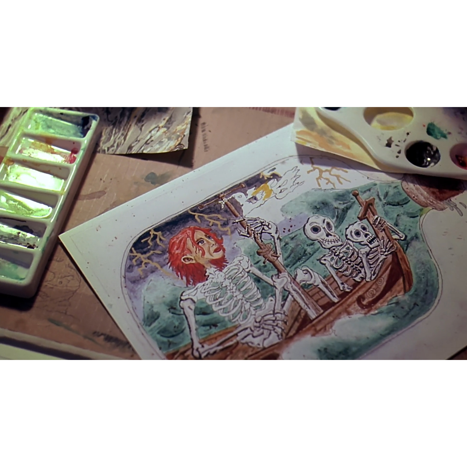 Overhead creative workspace view of a custom movie prop replica featuring Clementine painted like a skeleton from Eternal Sunshine of the Spotless Mind.