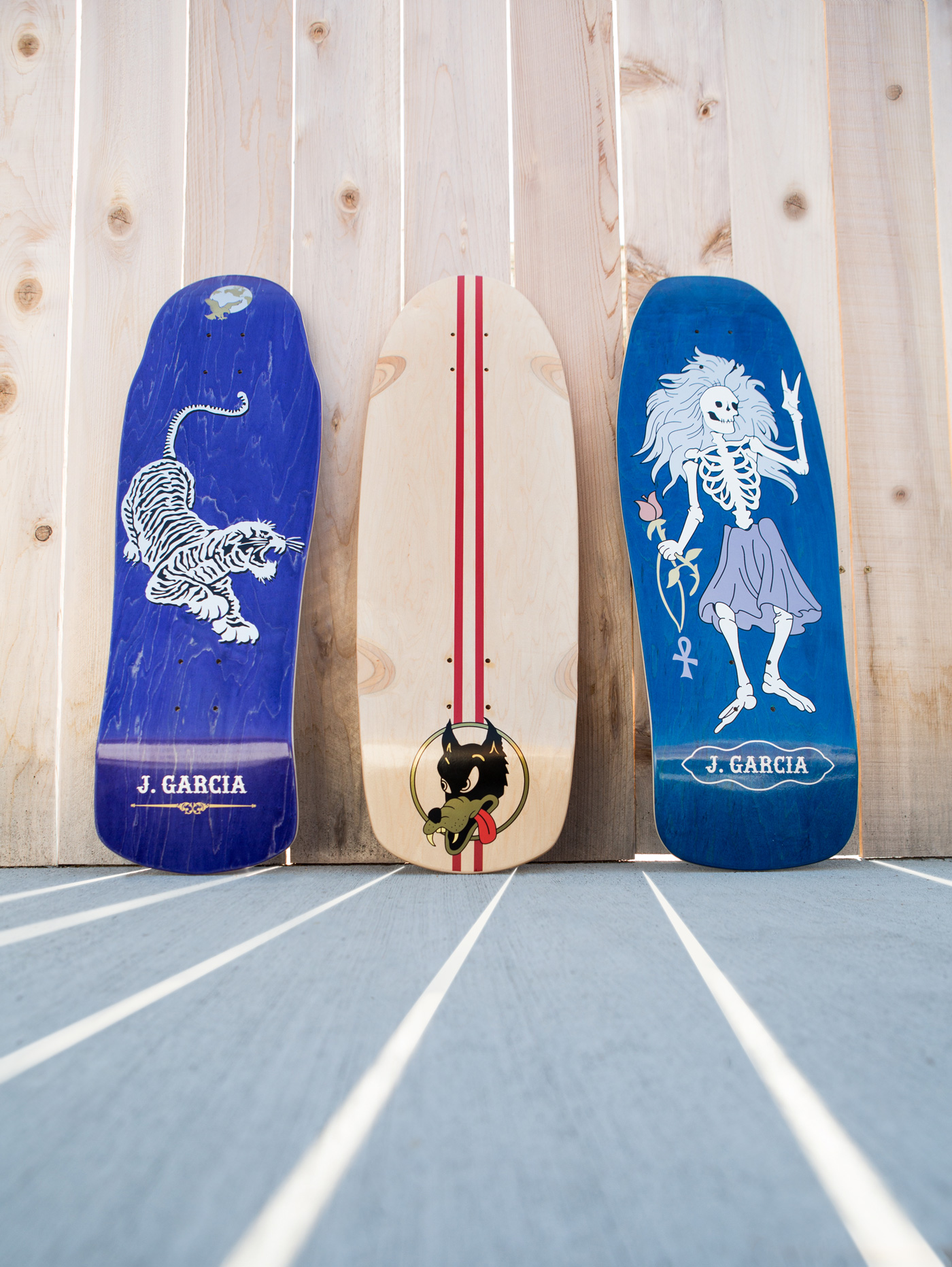 Graphic design portfolio display of official Street Plant Skateboards x Jerry Garcia custom decks featuring original Tiger and dancing skeleton artwork by Rob Wallace.